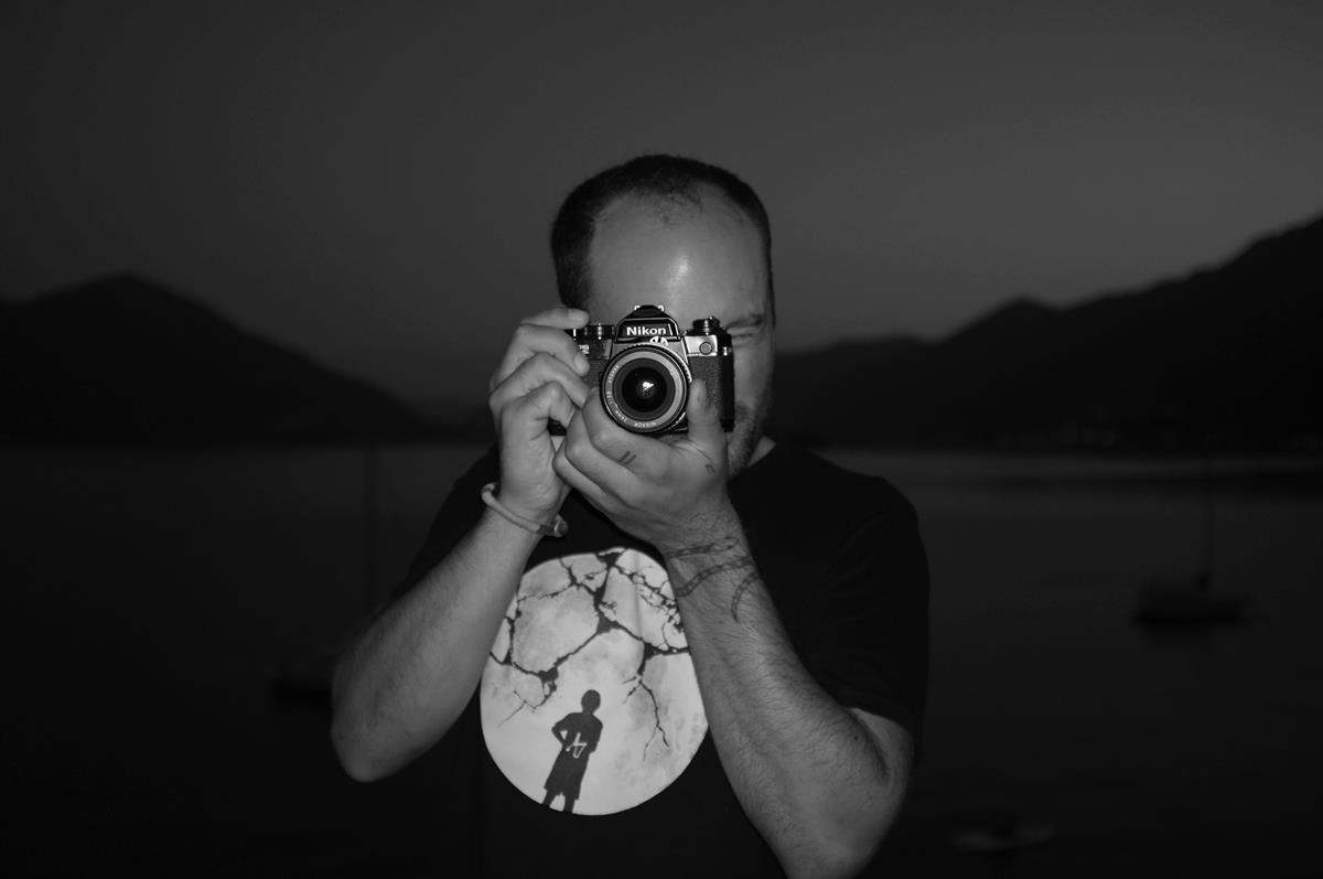 Armin Nussbaumer, a professional in the film and photography industry, looks through a camera